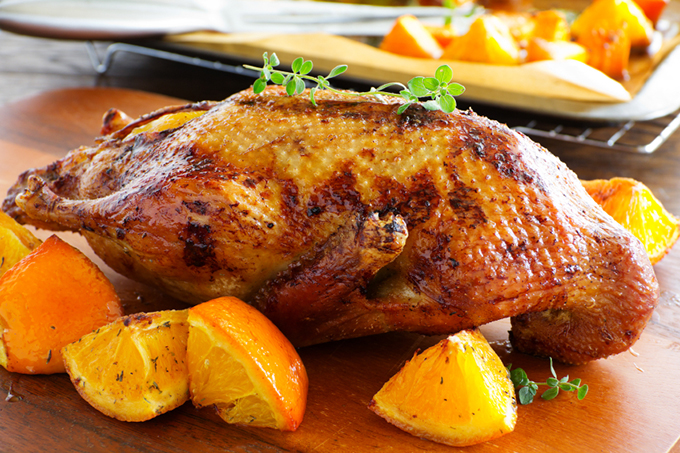 Roast duck with pumpkin and oranges.