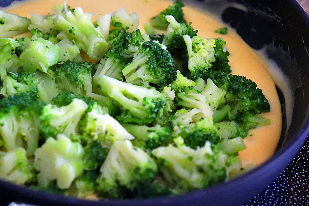 Adding the steamed broccoli to the sauce