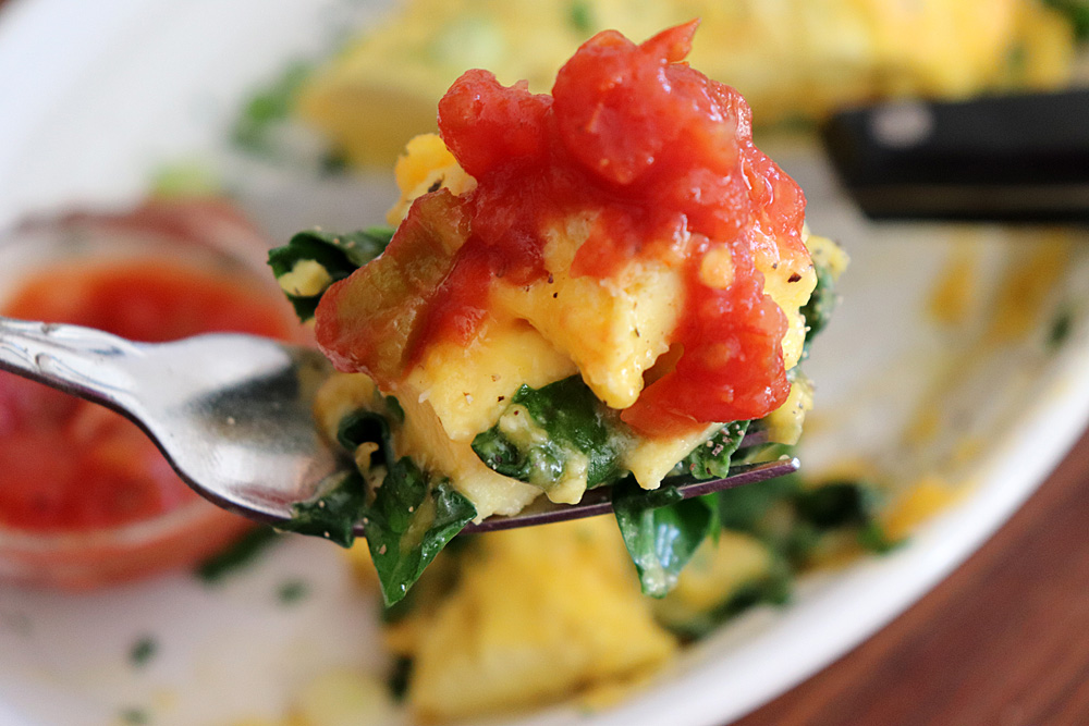 Bite shot of Easy Cheesy Spinach Omelet Recipe
