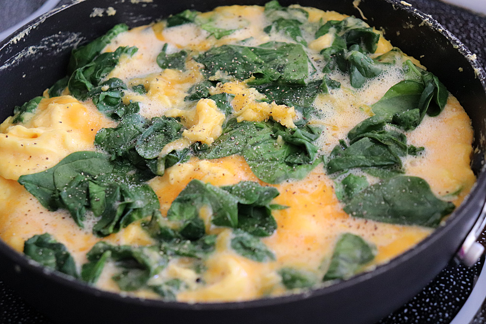 Partially cooked Easy Cheesy Spinach Omelet Recipe
